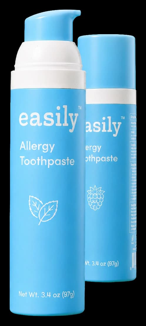 Two easily allergy toothpaste bottles — sky-blue pump dispensers, mint variant in front and raspberry variant behind, photographed on a clean backdrop.